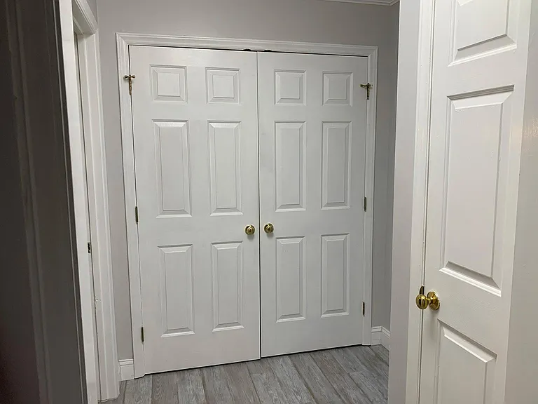 Hallway (linen closet on the right, bathroom doorway on the left, 2nd bedroom door also on the left, laundry closet straight ahead)