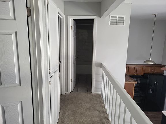 Upstairs hallway. Rooms to the left, full bathroom directly ahead.