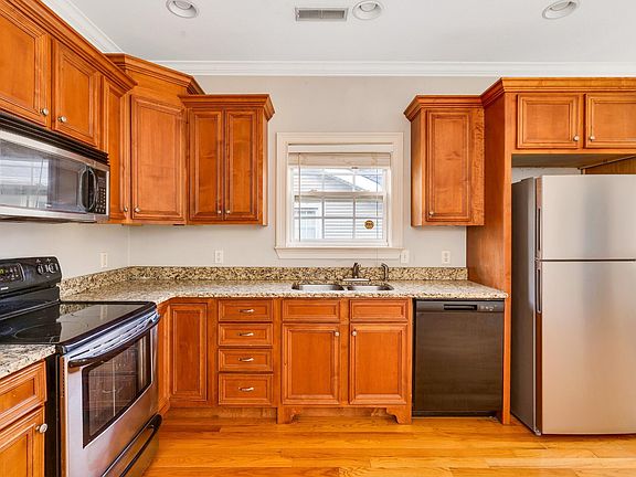 The kitchen has plenty of storage, granite countertops and updated appliances.