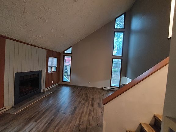 Dramatic HUGE WINDOWS all around with center fireplace in newly beautiful renovated house with new flooring. Ask us how our realtor helped us to use AI to design this rennovation!