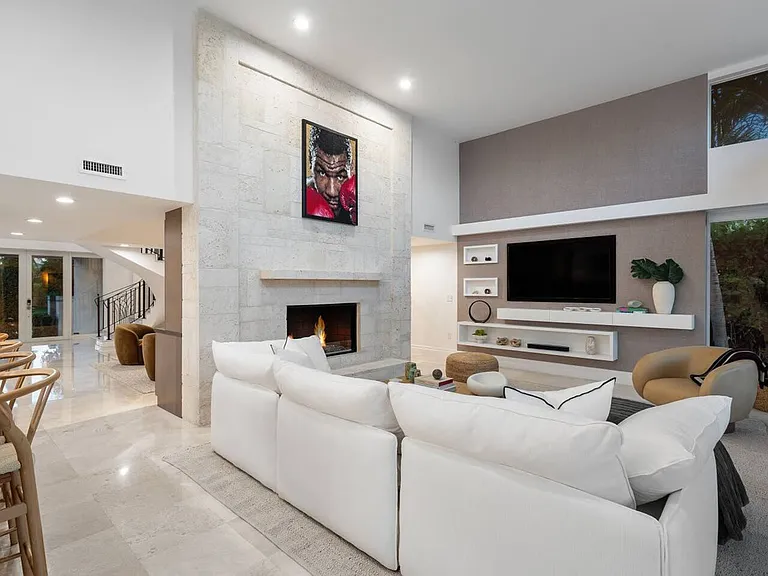 Refined living space centered around a sleek fireplace and surrounded by open views.