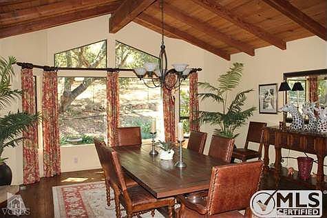 Luxurious dining room offers peaceful views of the backyard and meadow beyond.