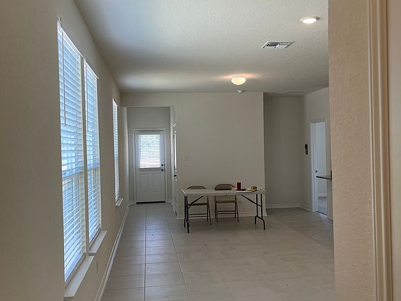 From the entry looking through the large main living area to the back door.