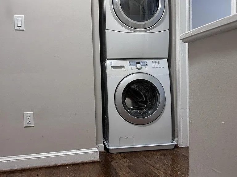 Convenient in-home laundry nook with a stacked front-loading washer and dryer for easy everyday use.