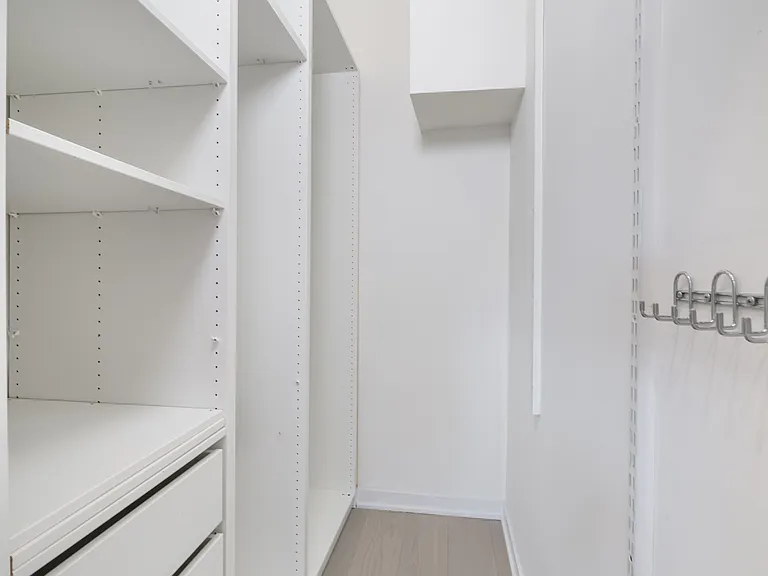 Custom closet with space for all types of clothes and ironing board
