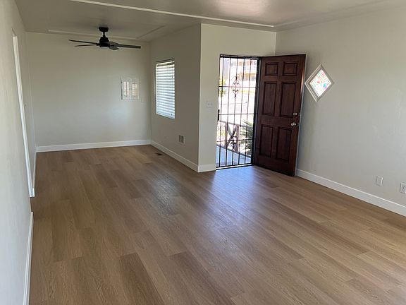 Dining Area with new flooring and ceiling fan. Pass through window to kitchen.