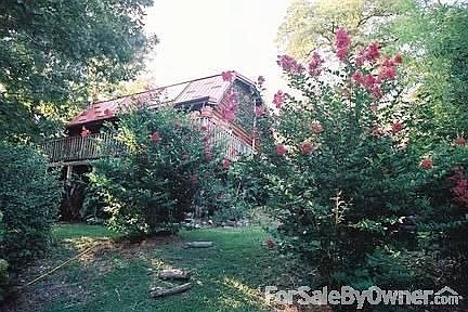 View of the Log Home & Garden
						:
						Looking back from the lake path, the view is just as beautiful