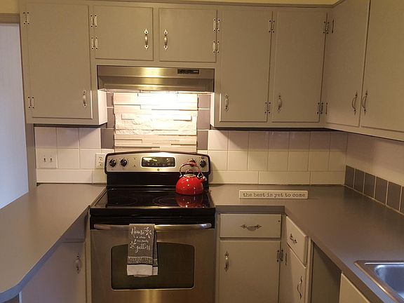 Beautiful stone backsplash feauture over stainless steel range.