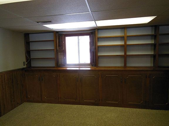 The family room has built in storage shelves and cabinets.  Your library collection will fit here nicely. 