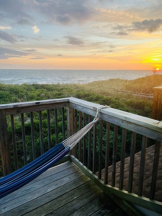 Sunrise over the hammock off the waterfront bedroom balcony!