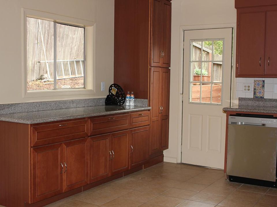 Extra cabinets, door off kitchen leads to private yard.