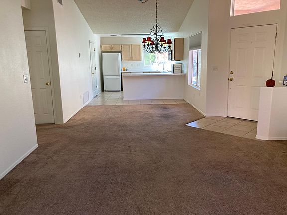 Open concept living room, dining room, and kitchen, located just off of the front door.