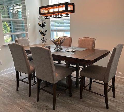 Dining area with leaf added in to spaciously accommodate 6 guests. There are 2 additional benches are available to seat up to 10 guests. Invite the neighbors for a poker night.