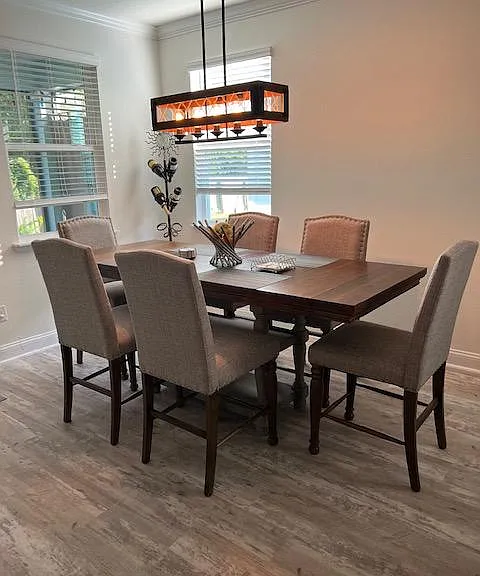 Dining area with leaf added in to spaciously accommodate 6 guests. There are 2 additional benches are available to seat up to 10 guests. Invite the neighbors for a poker night.