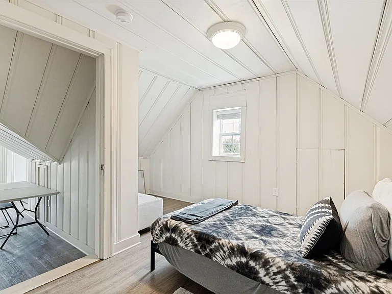 This space is set up as a quaint bedroom but could be an office or closet.