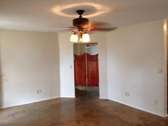 Living room with saloon doors leading into hallway