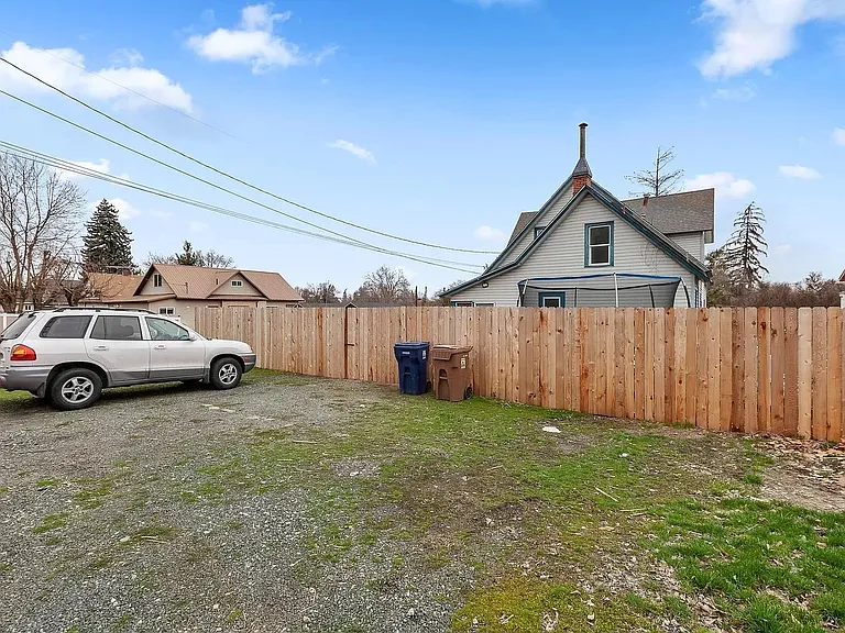 Parking area in rear of house. Enter through gate in fence.