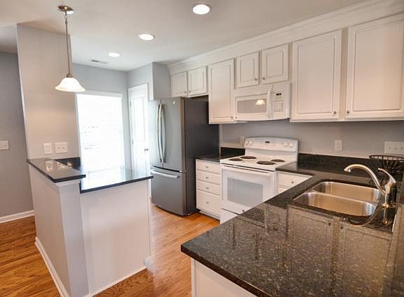 Open kitchen with pantry and granite countertops. Includes appliances (stove, fridge, dishwasher, garbage disposal, microwave)