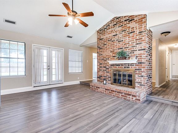 Several windows provide ambient into the adorn the living room with gas fireplace