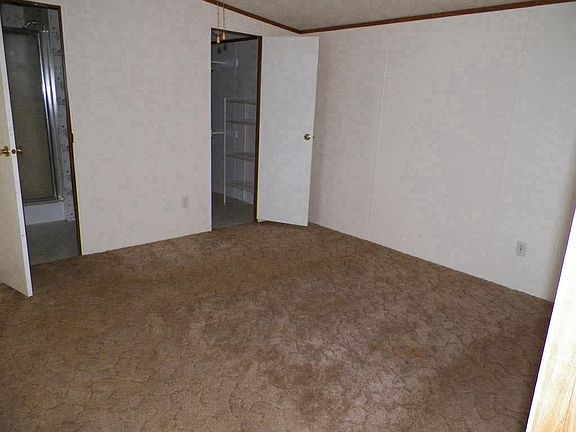 Split master bedroom has walk in closet, ceiling fan