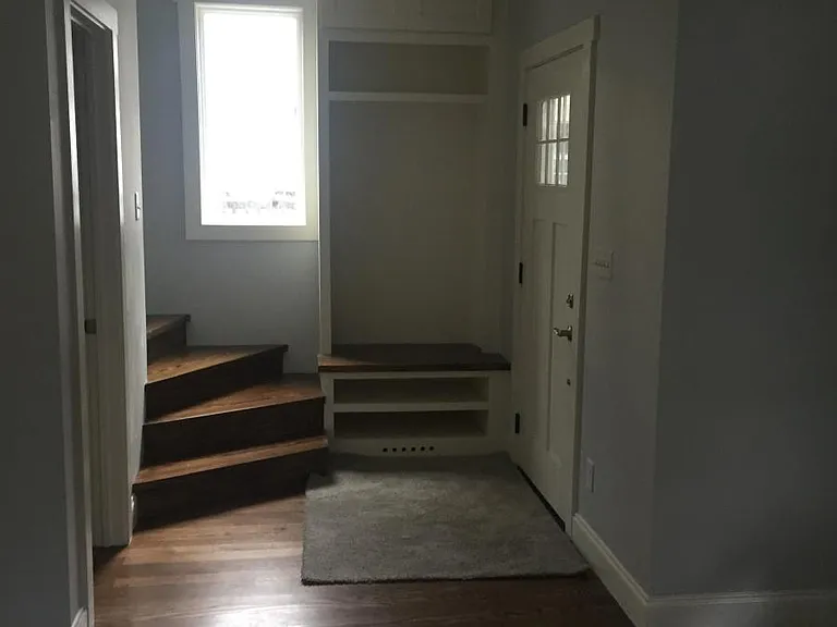 Entrance with built in coat rack and shoe bench