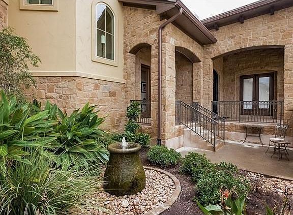 A carefully manicured yard, walkway and courtyard offer an inviting entrance for your guests