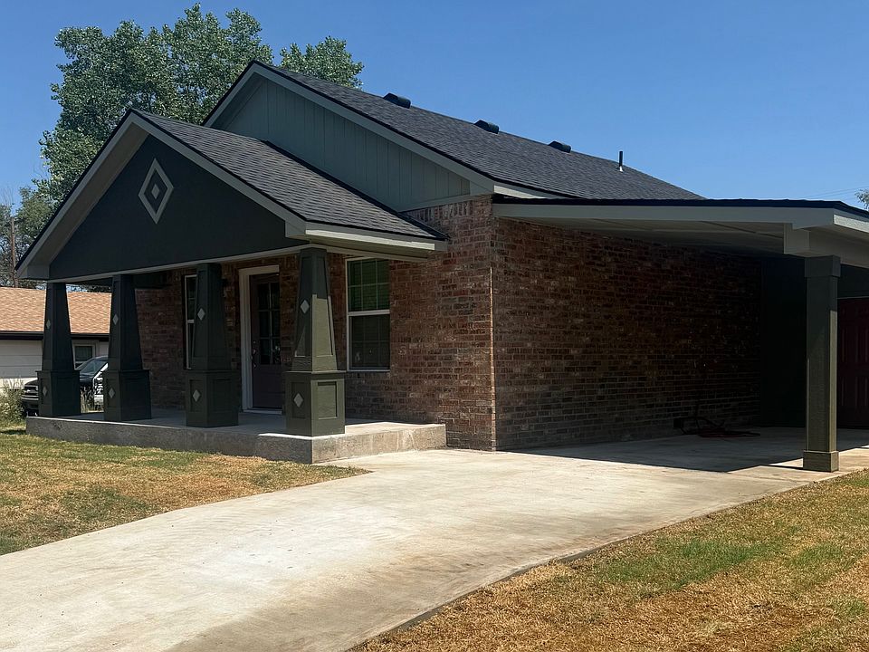 Updated brick home with a covered front porch, covered patio, carport and nice storage.