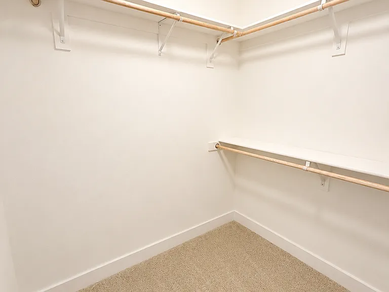 Spacious walk-in closet with ample hanging space and storage