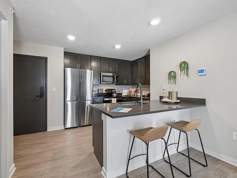 A stylish kitchen with inviting seating and modern finishes creates the perfect setting for everything from morning coffee to casual gatherings.