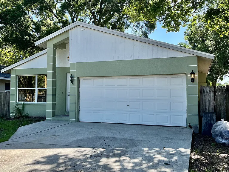 Large driveway with 2 car garages