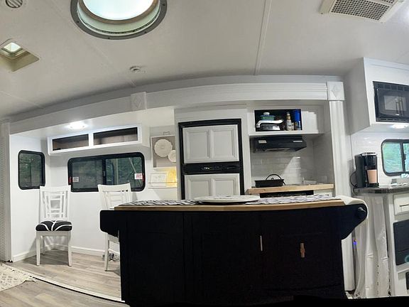 open living kitchen with island fireplace and tv