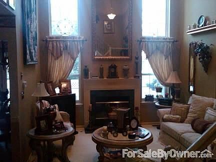 Living room with large paladium windows : Large two-story living room with gas fireplace, upgraded c