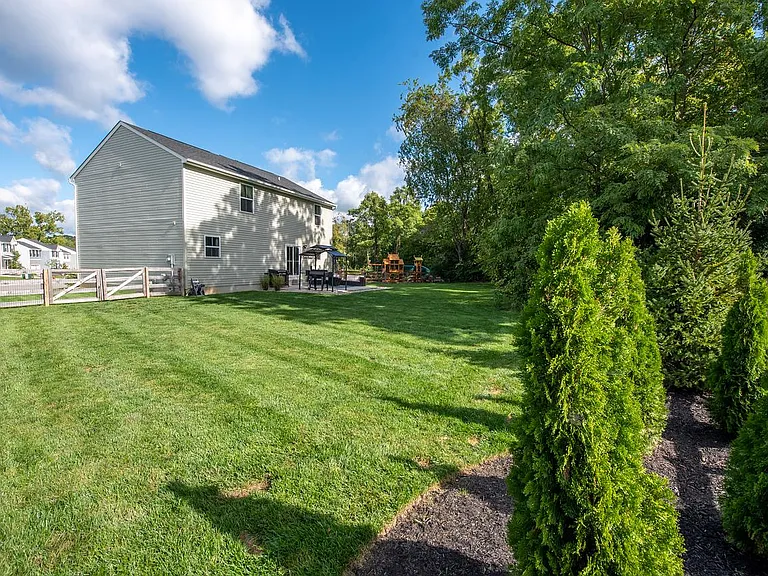 Rear Flowerbed with Arborvitae Provide Even More Privacy as They Grow.
