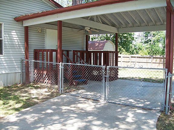 Covered carport and side entrance into utility room and kitchen.  Back yard is fully fenced.
