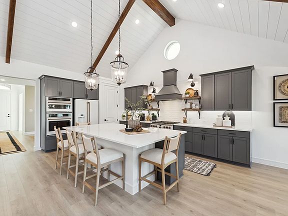 Kitchen with vaulted ceiling and pendant lighting