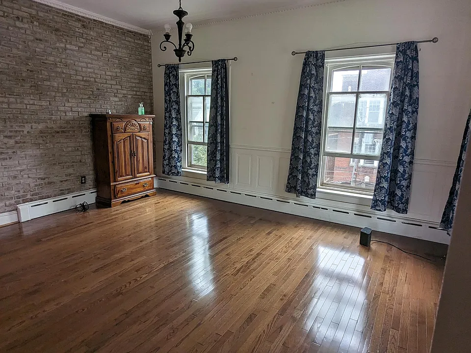 Living room with tall ceilings and beautiful hardwoods!