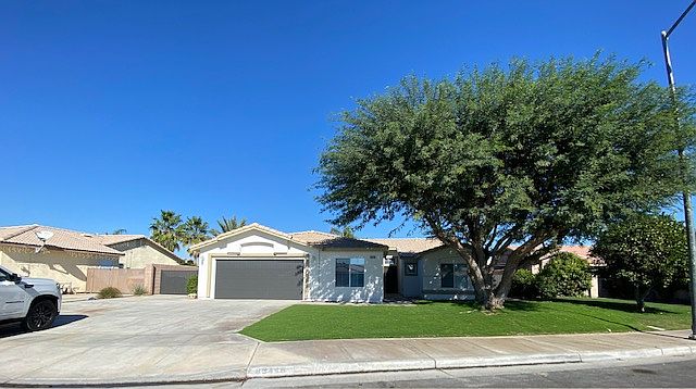 Exterior with extended driveway, gated RV parking on side yard, 2 car garage, and brand new paint.