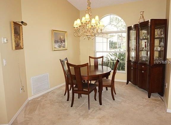 Large half round window, vaulted ceiling, chandelier conveys.