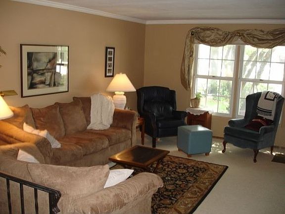 Fresh Carpet, Paint, and Crown Mouldings in Living Room