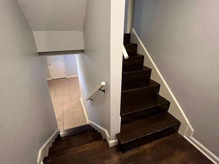 Hallway leading upstair showing off the hardwood floors