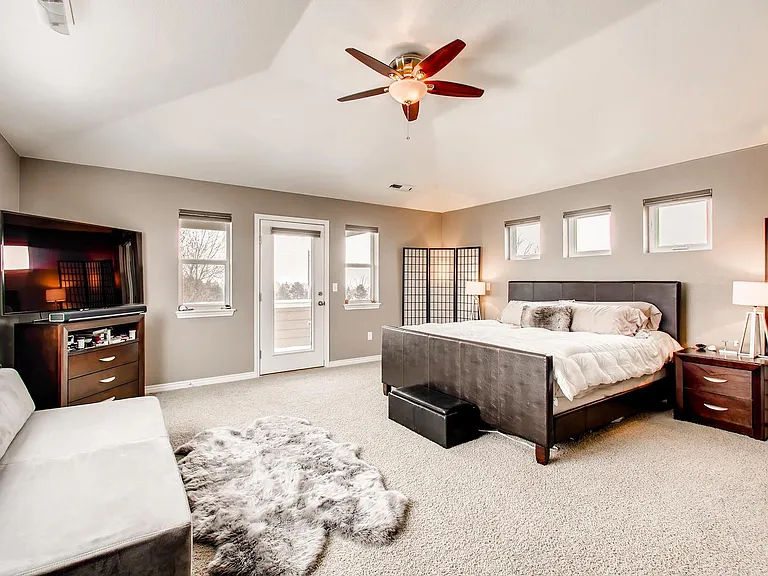 Huge Primary bedroom with vaulted ceilings and deck