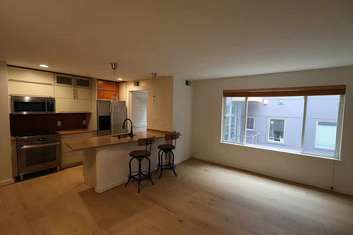 View from the living room into the kitchen. - 1439 Chapin St NW #202