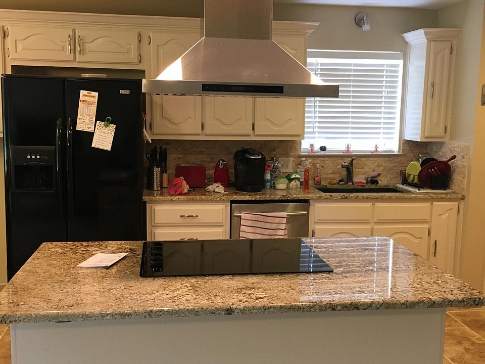 Kitchen with granite island and cook top