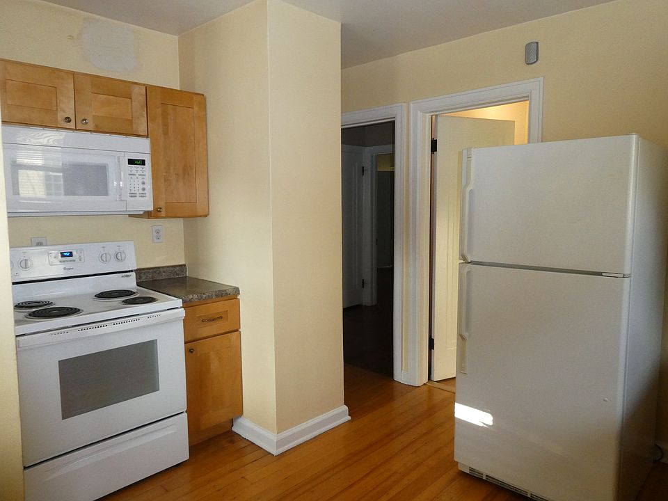 Kitchen with hardwood floors and appliances.