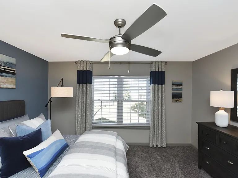 Cozy bedroom with carpet and ceiling fan