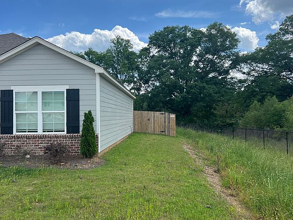 Right side of house with gate to backyard and no neighbor this side.