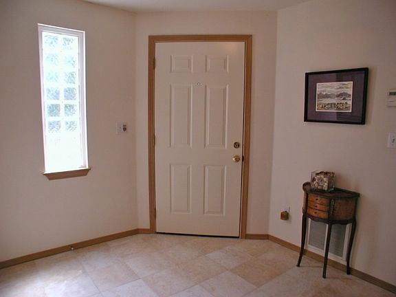 Light and welcoming tiled entry. The perfect place to leave shoes and that wet umbrella! Large enough for a good size sideboard (not in photo).