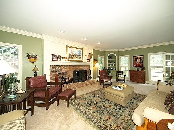 Family room has a wonderful wood burning brick fireplace, recessed lighting