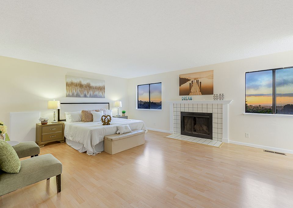 Master suite with two windows facing bay sunset