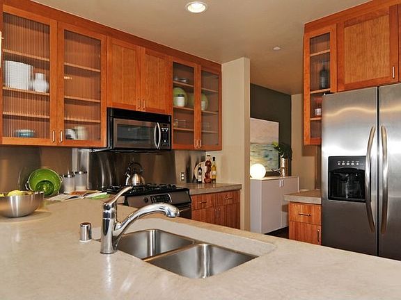 Kitchen includes: gas range, concrete counters, stainless appliances